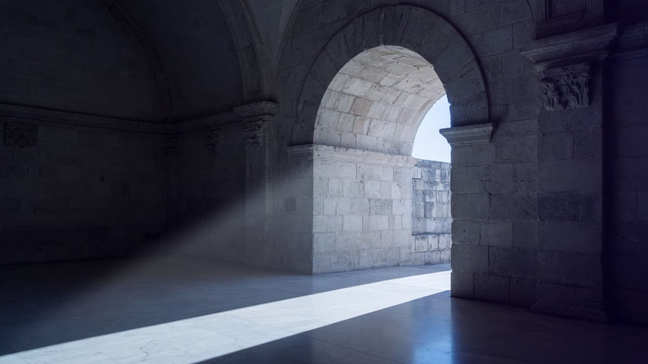 Stone archway with a shaft of daylight
